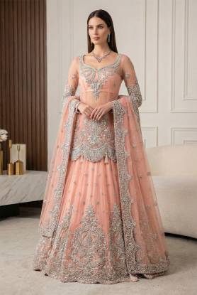 Melon Pink  net shirt paired with a melon pink net lehenga, positioned for Pakistani bridal dresses, bridal wear, bridal outfits, bridal couture, bridal gown and lehenga styles, traditional Pakistani bridal wear, designer bridal dresses, and bridal dresses for Pakistani brides.