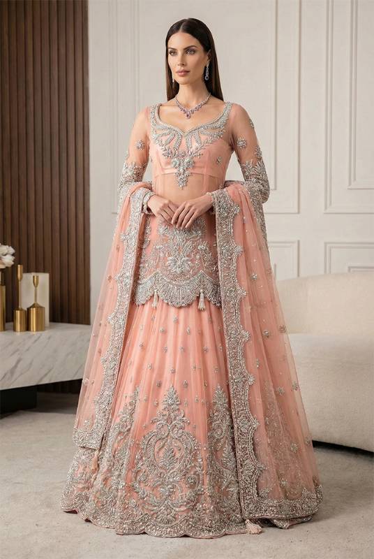 Melon Pink  net shirt paired with a melon pink net lehenga, positioned for Pakistani bridal dresses, bridal wear, bridal outfits, bridal couture, bridal gown and lehenga styles, traditional Pakistani bridal wear, designer bridal dresses, and bridal dresses for Pakistani brides.