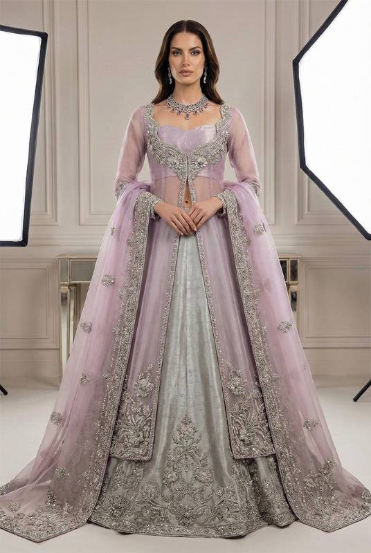 Maverick net jacket with a light silver raw silk lehenga for Pakistani bridal trousseau, embroidered bridal dresses, custom Pakistani bridal outfits, bridal fashion in Pakistan by bridal dress designers in Pakistan, showing latest bridal dress designs and designer bridal dresses for Pakistani brides.