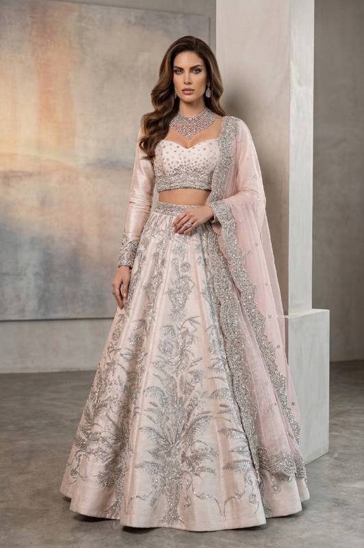 Cinderella Raw silk Blouse and Lehenga is a Pakistani bridal lehenga choli with heavy embellishments for nikkah ceremony. Find this Nikah ceremony attire at Pakistani bridal lehenga choli stores in Houston and Chicago.